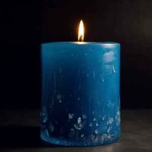 Hand-poured Ocean Breeze Candle in a glass jar with seashells and driftwood accents.