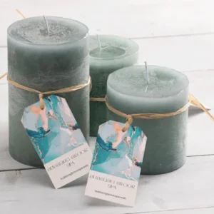 Set of Ocean Breeze Candles in glass jars with seashells, driftwood, and soft blue tones.
