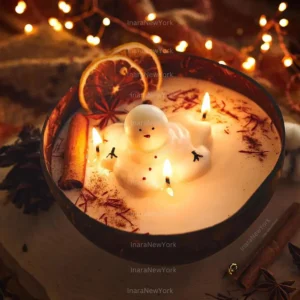 Hand-poured Snowman Candle with a smiling snowman design and soft holiday lighting.